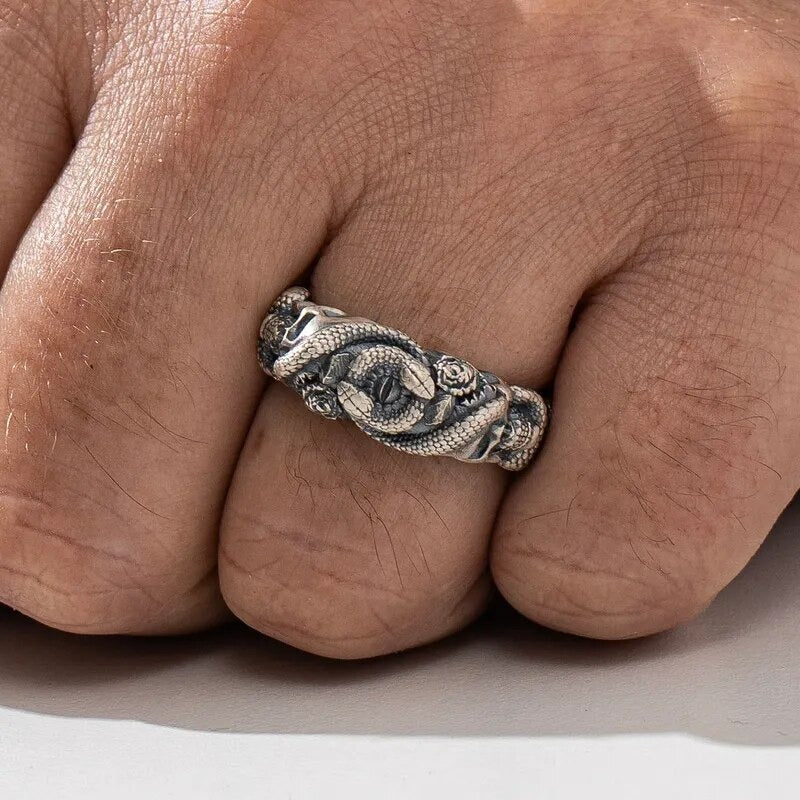 men's hand wearing a gothic ring