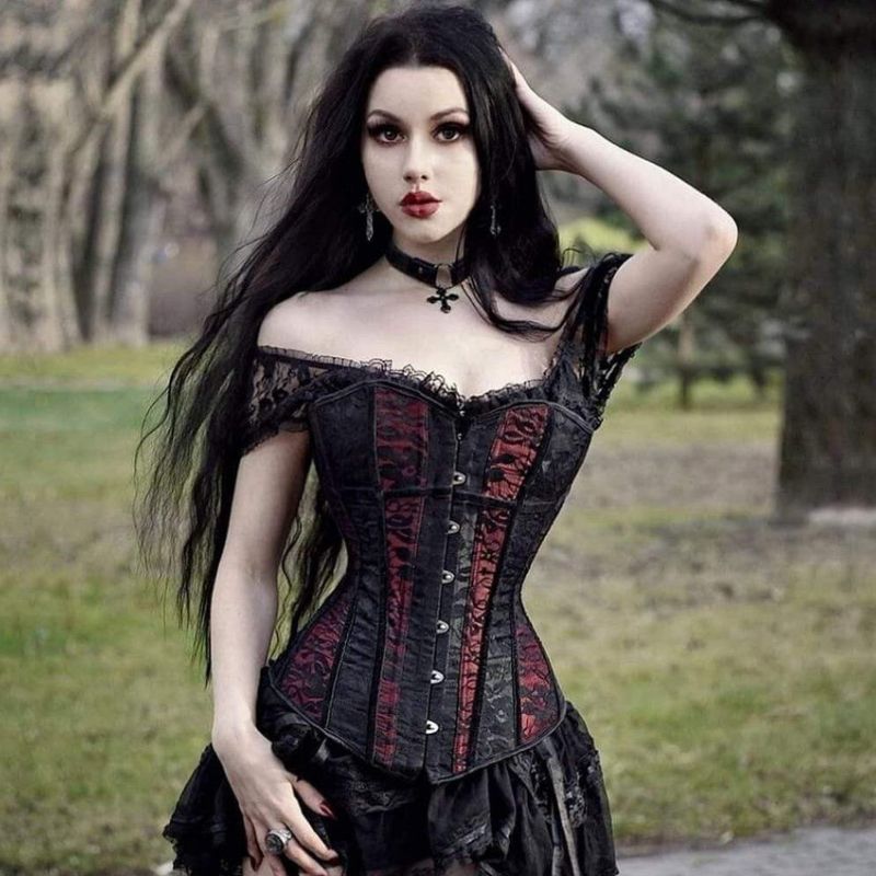 young woman with black hair wearing a steampunk gothic corset