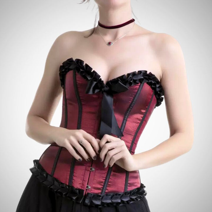 woman wearing a black and red steampunk corset with a bow