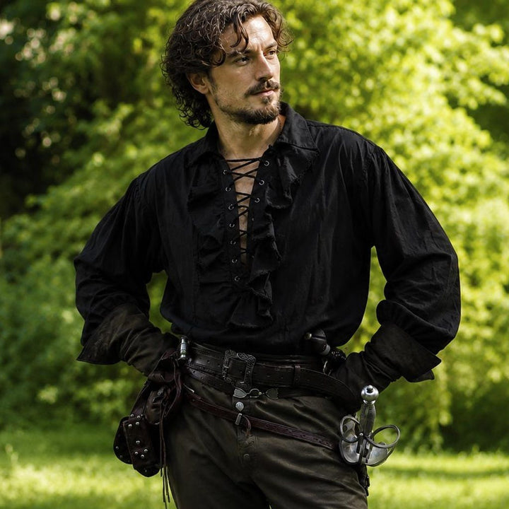 man wearing a black ruffle shirt in a pirate style