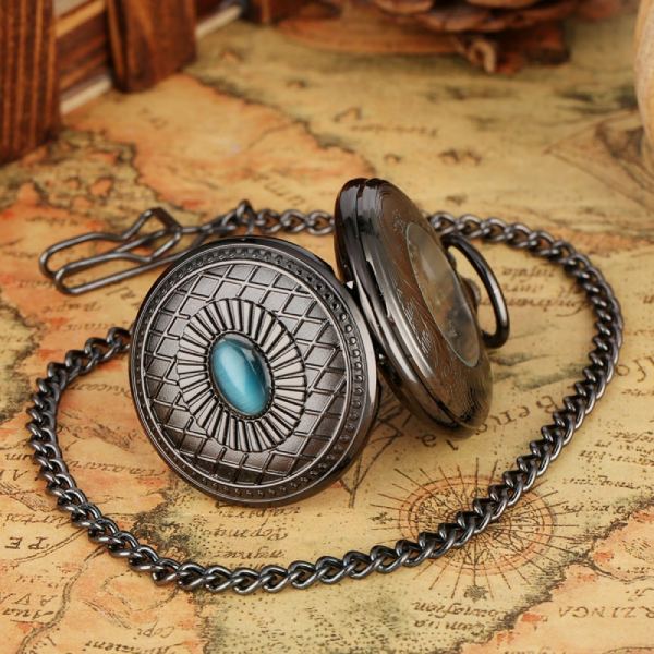 dark pocket watch with blue stone