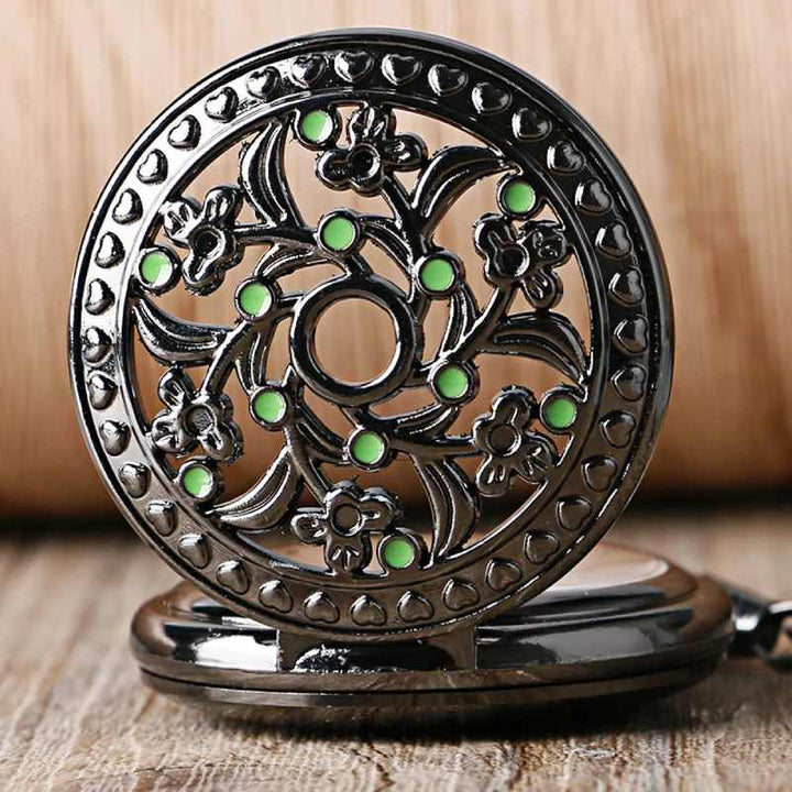 pocket watch with green stones